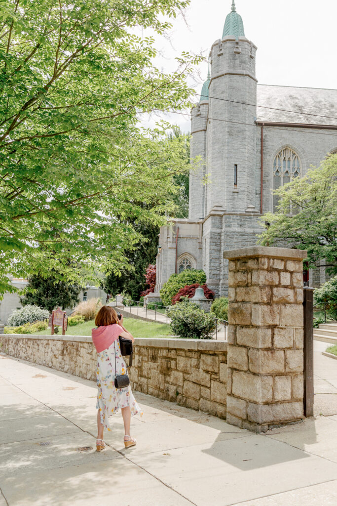 Wedding guest taking a picture of St. Bridget's Church in Philadelphia by Vay Photo