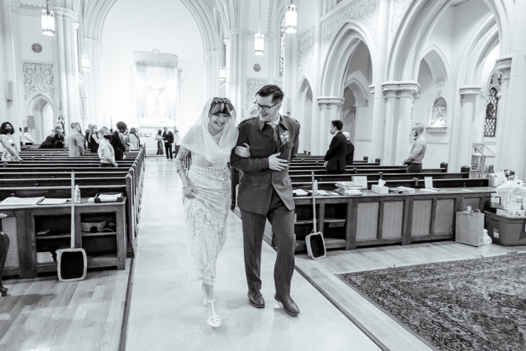 Bride and groom exiting the church on a spring wedding day in Philadelphia by Vay Photo