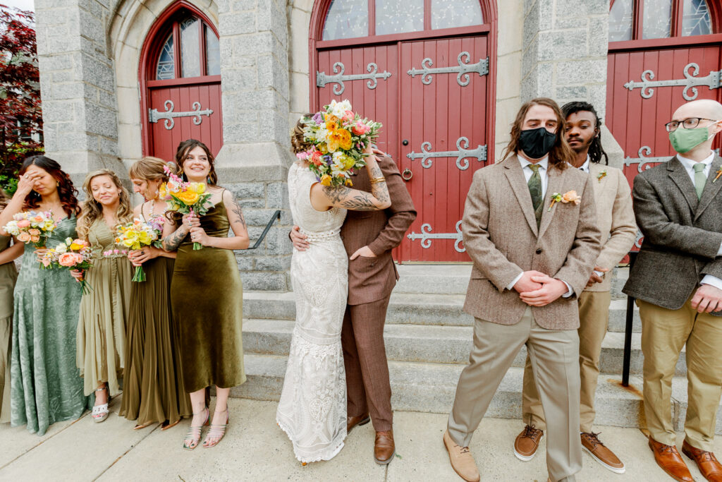 Bride and groom kissing outside the church by Pennsylvania wedding photographer Vay Photo