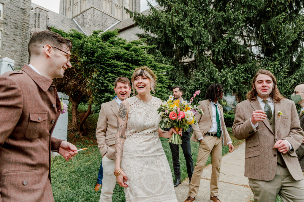 Bride with the groomsmen outside of a church in Philadelphia by wedding photographer Vay Photo