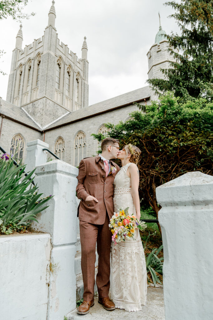 Newlyweds kissing outside the church during a spring wedding in Pennsylvania