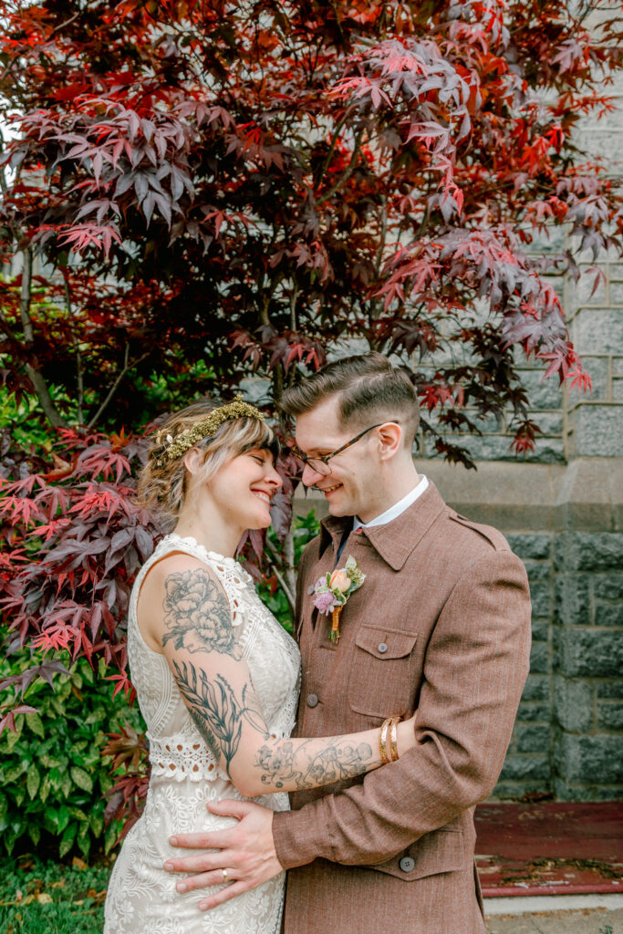 Bride and groom smiling at their small spring wedding in East Falls