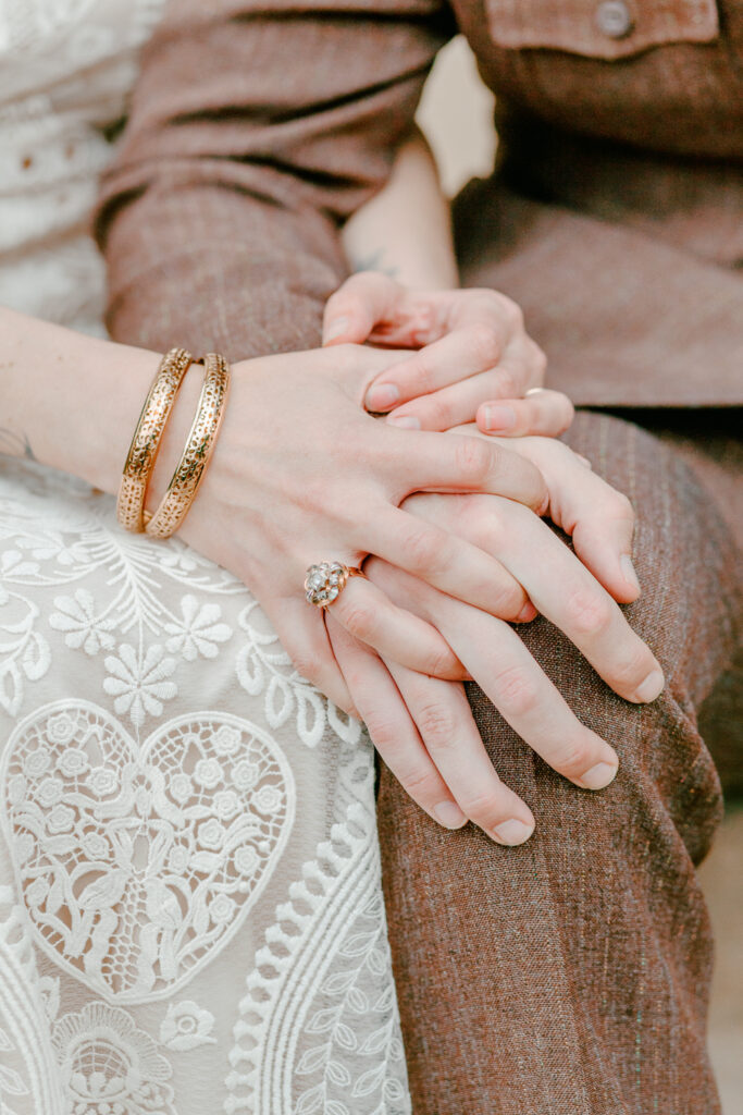 Bride and groom's clasped hands on an intimate spring wedding day in Pennsylvania