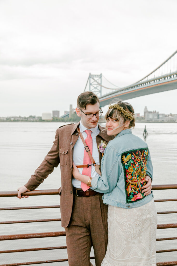 Bride and groom on the Delaware River waterfront on a spring wedding day in Philly