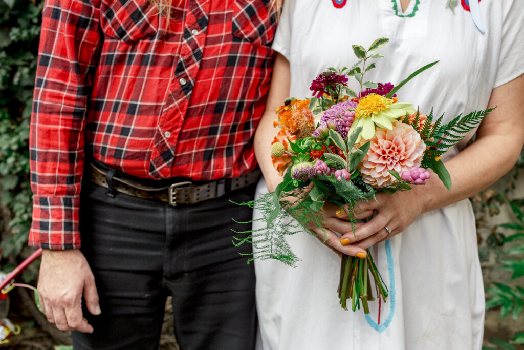 Colorful bouquet of zinnias and dahlias for a casual backyard elopement