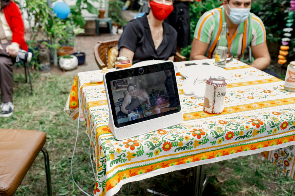 Wedding guests join over zoom during a backyard COVID wedding