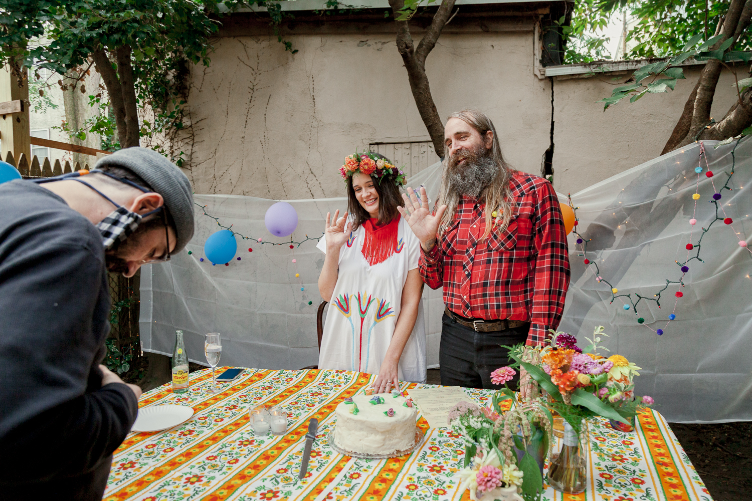 Newlyweds waving to their guests on Zoom during a COVID wedding in Philadelphia