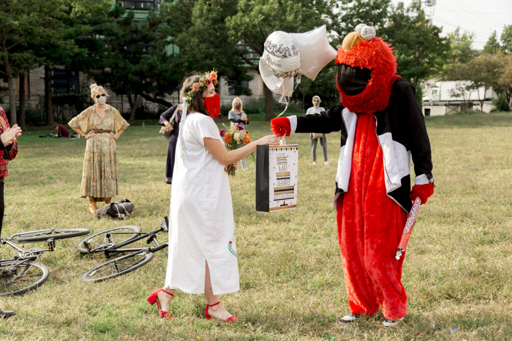 Philly Elmo gives the bride balloons after a small wedding ceremony in Philadelphia